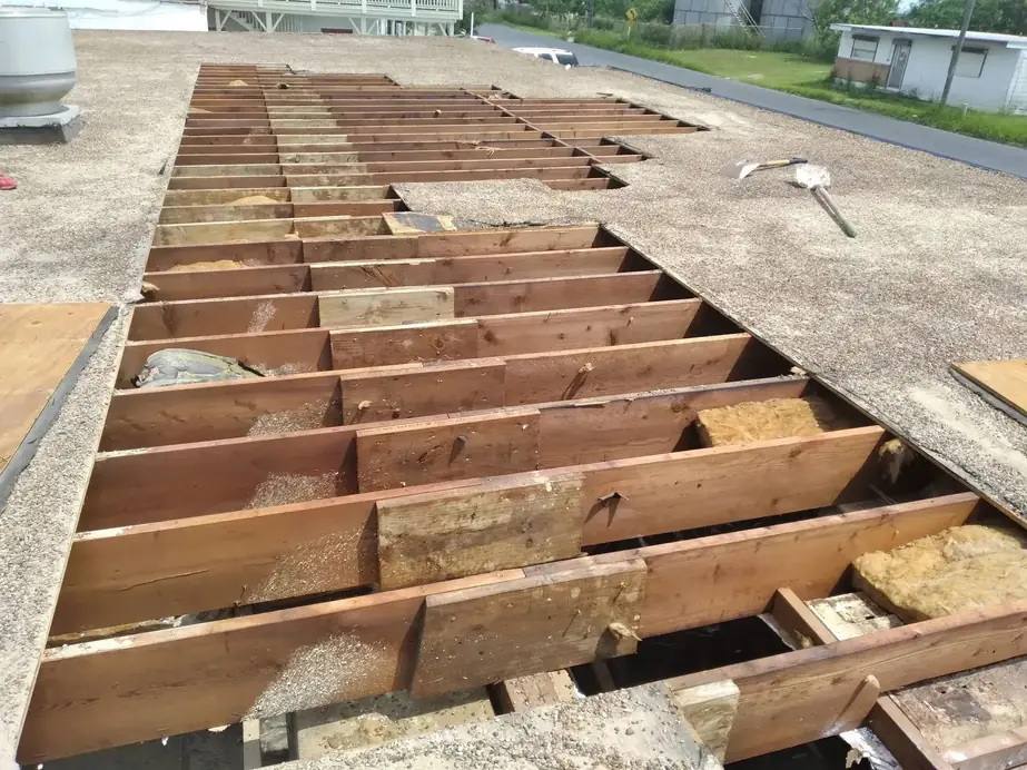 Open rafter bays with old decking cut back on a flat roof