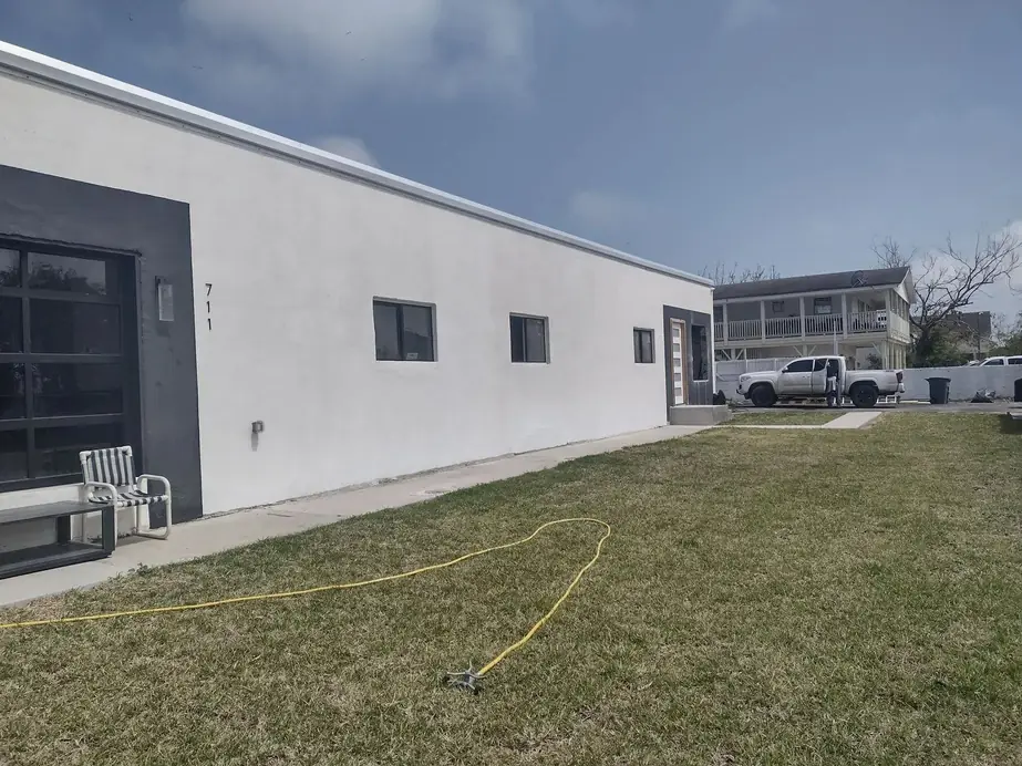 Finished side wall of the white stucco building